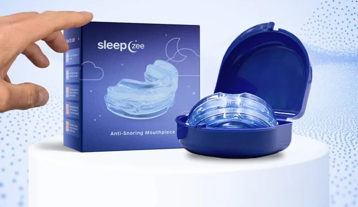 SleepZee box beside its open blue carrying case with the translucent mouthpiece inside